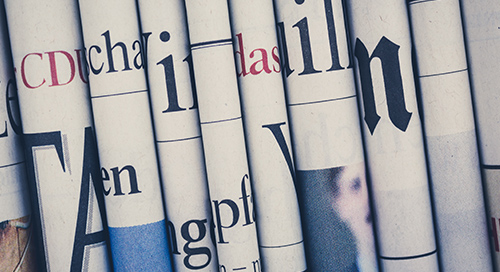 closeup of vertically stacked newspapers