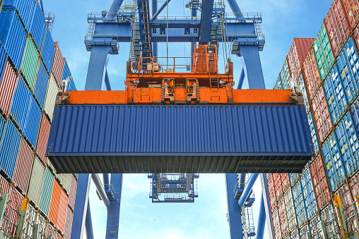 lift loading shipping containers onto freight ship