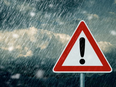 triangle sign with exclamation mark in heavy rain