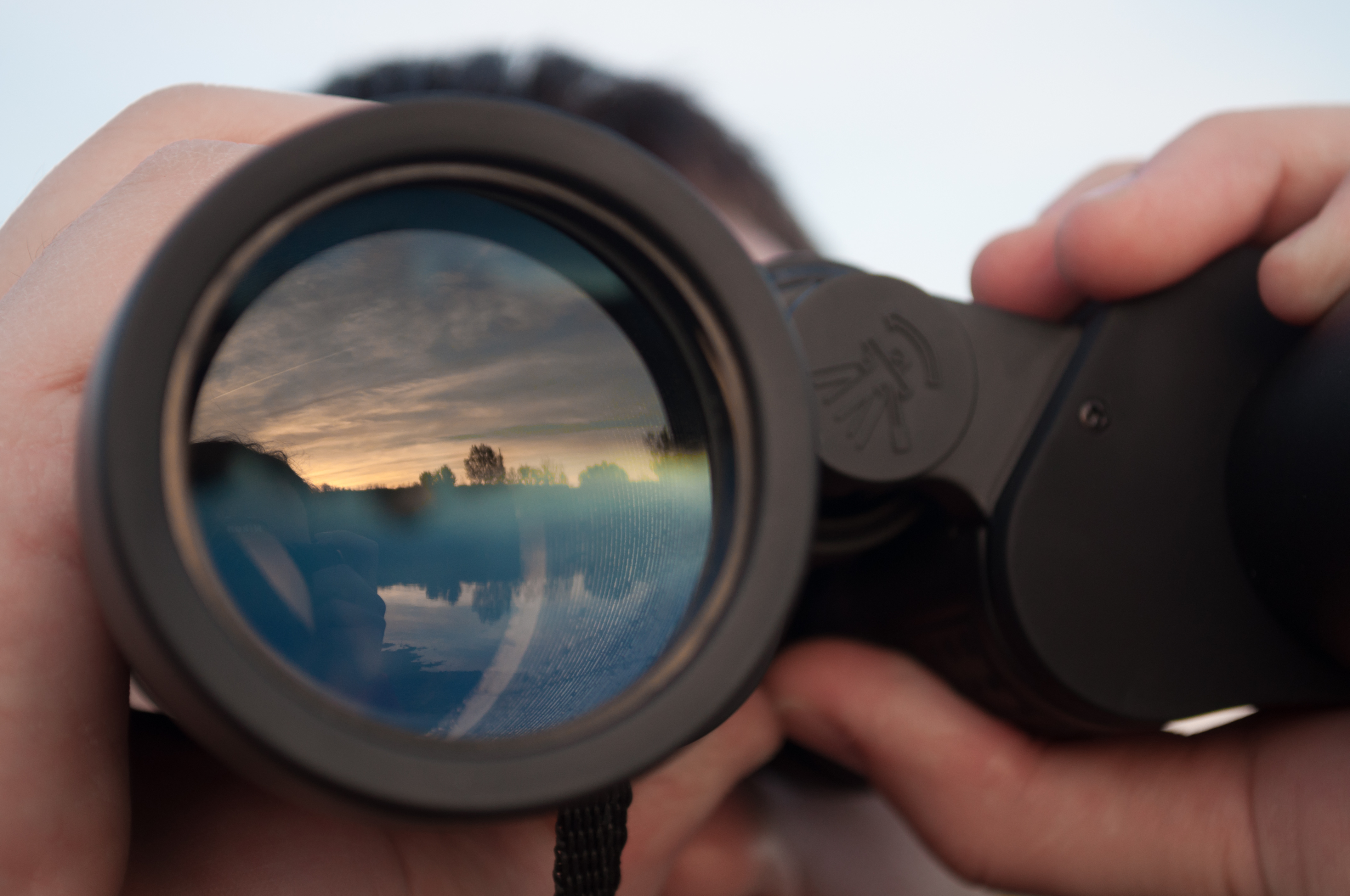 man looking through binoculars closeup