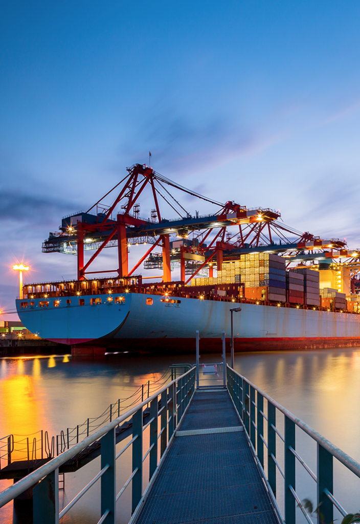 Cargo ship leaving port at night