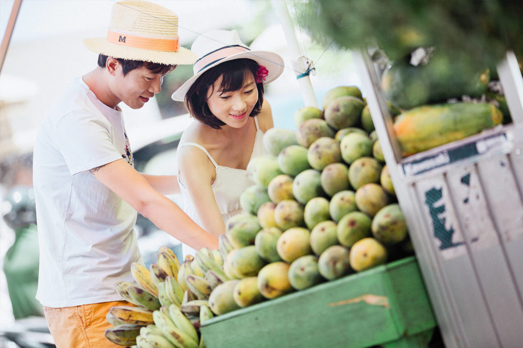 couple shopping for fresh fruits at a market