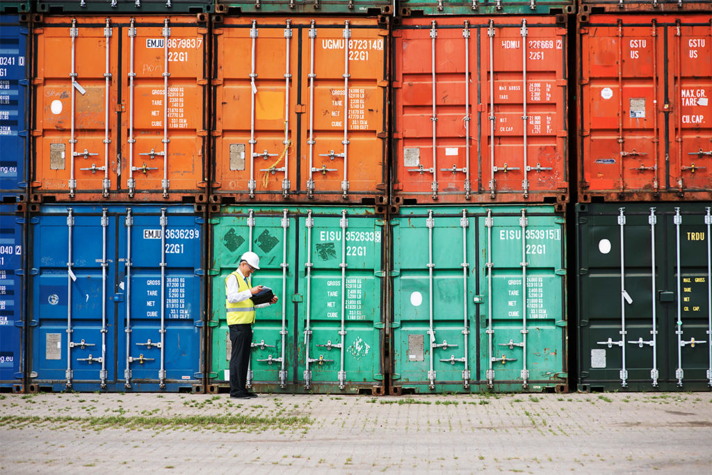 worker checking shipping containers