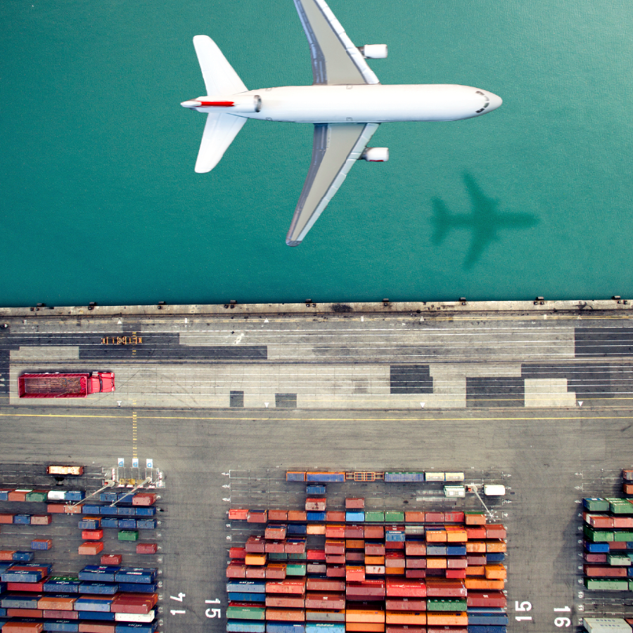 Logistics as a Service - How Logistics Experts Can Reduce Spend, Save Time and Increase Company Profits 1 plane flying over shipping yard